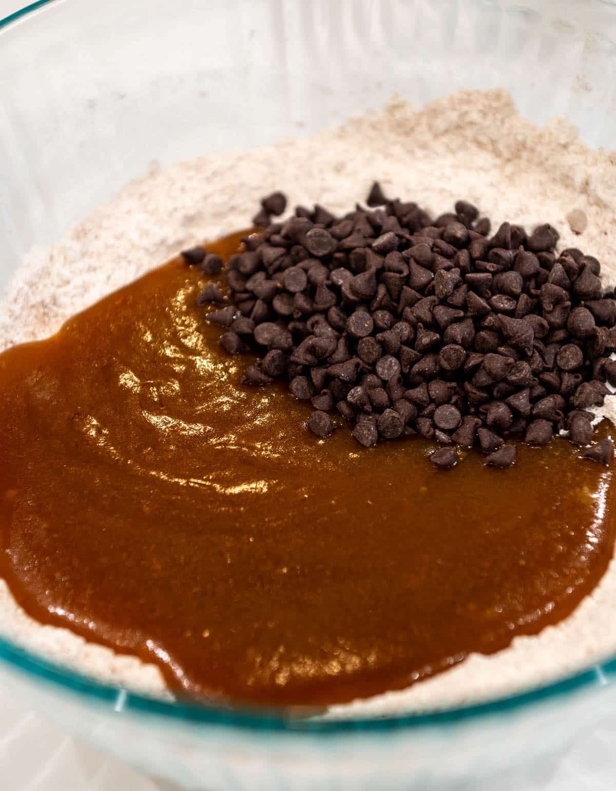 Dry and wet ingredients added together with chocolate chips.