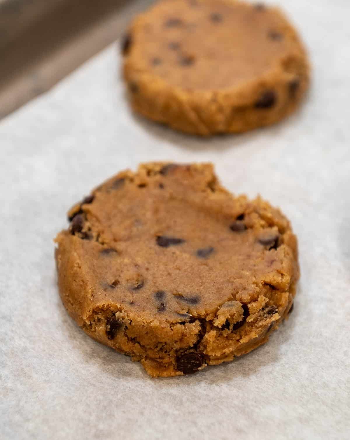 Cookie dough is flattened. 