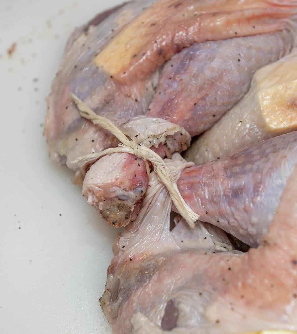 The turkey's legs are tied together. 