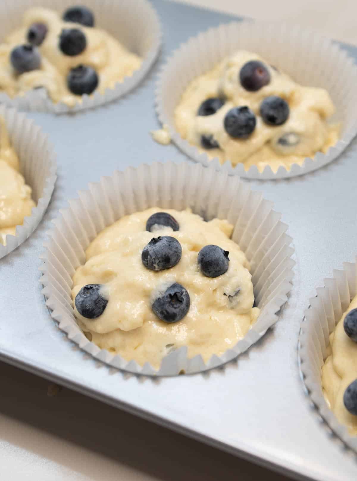 Batter is placed into the lined muffin tin. 