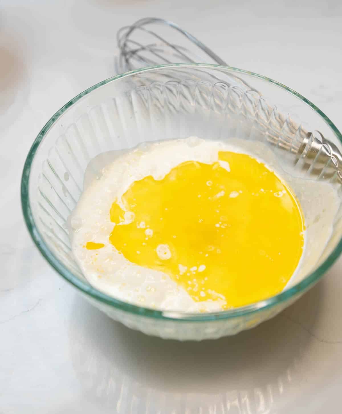 Melted butter and sourdough starter discard are added to the bowl of dry ingredients. 