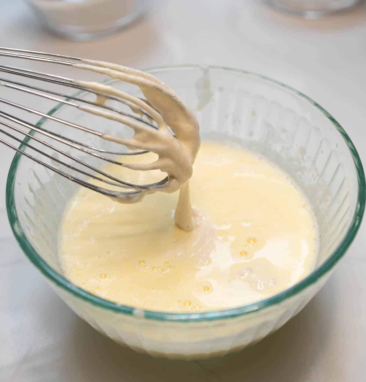 Dry and wet ingredients are mixed together with a large whisk. 