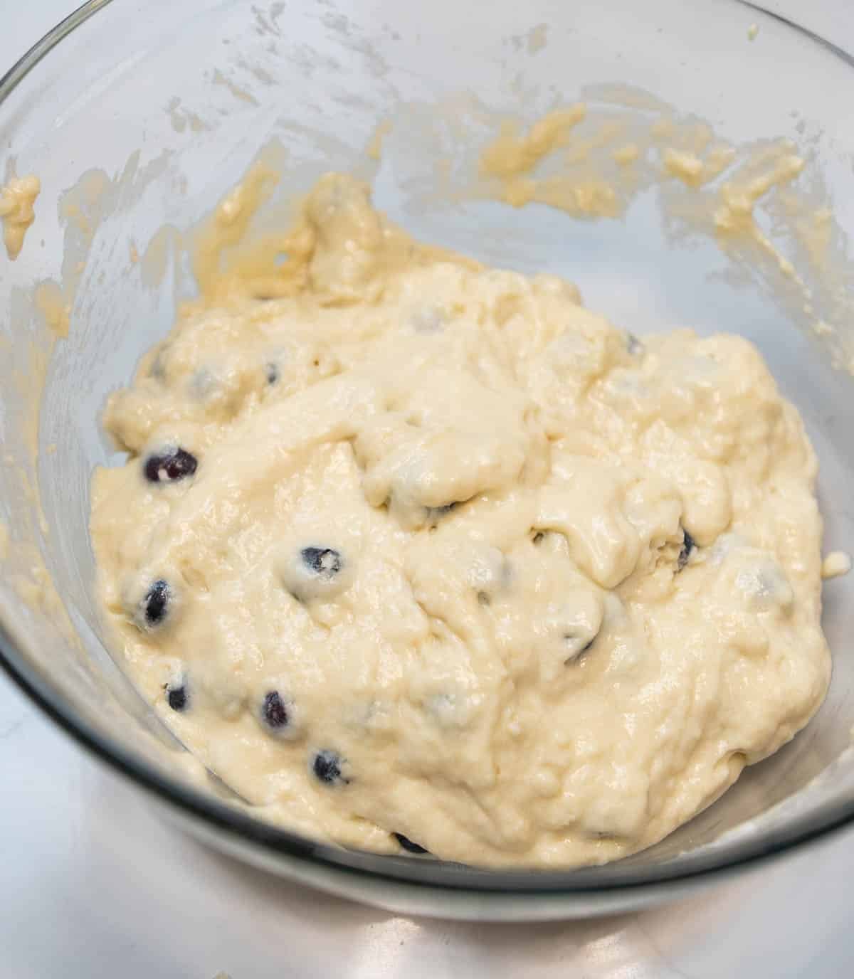 The sourdough discard blueberry muffins batter is ready. Blueberries are fully incorporated after being folded into the batter. 