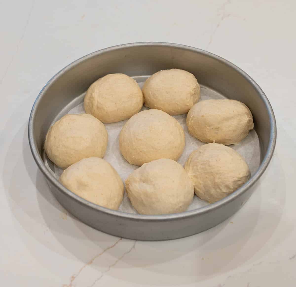 Shaped rolls in a pan.