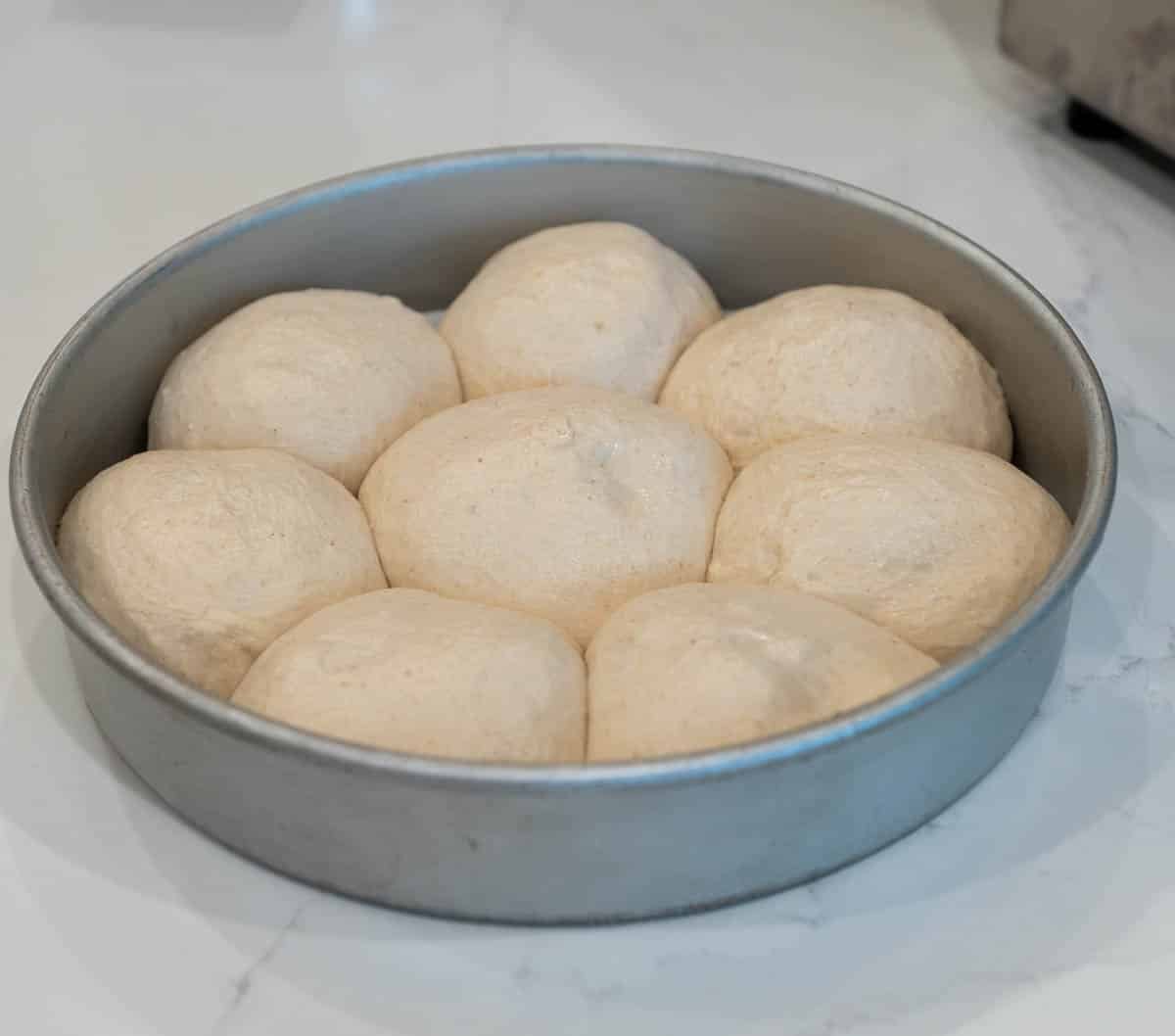Rolls are fully risen in pan. 