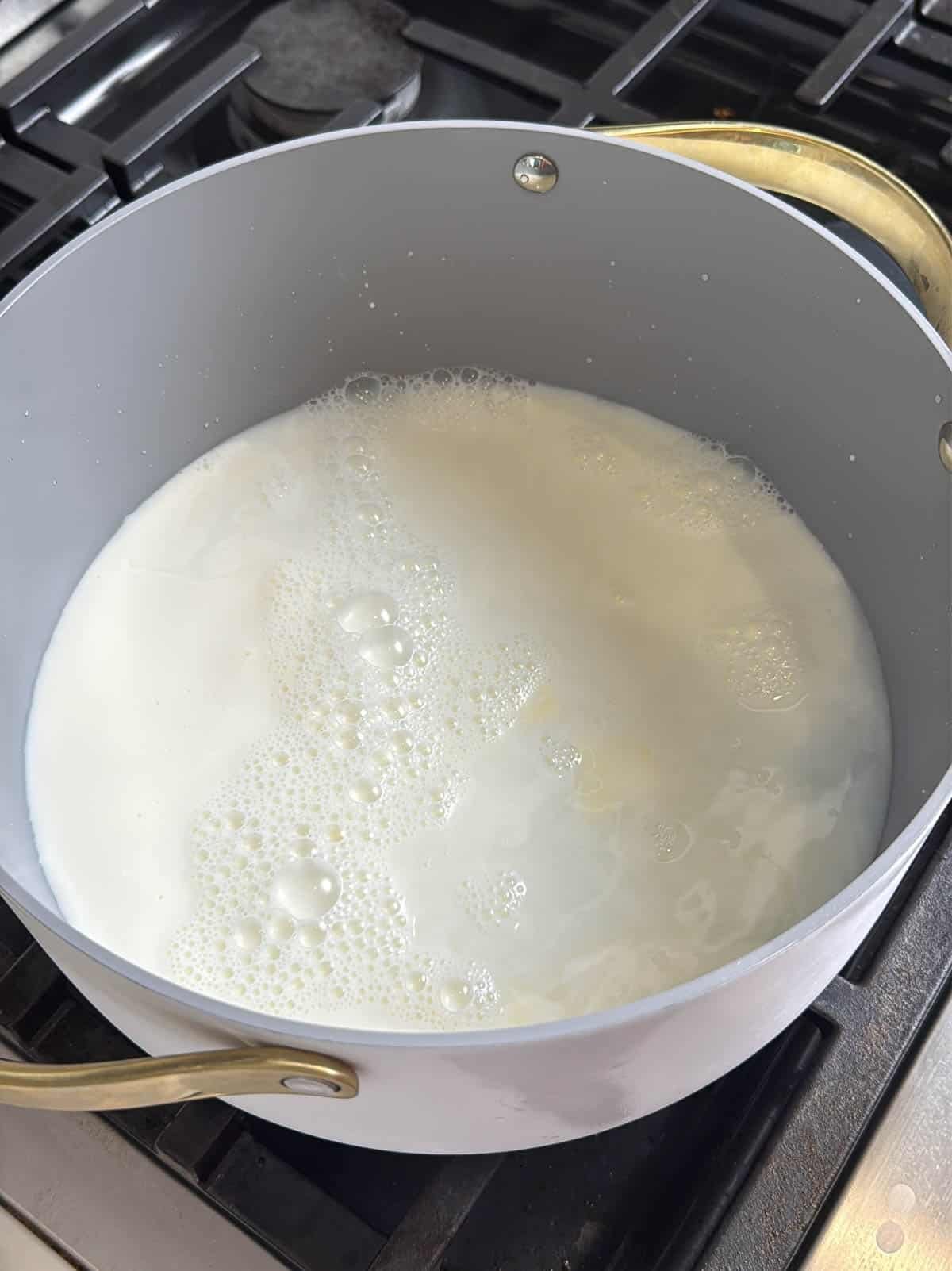 close up of boiling water and milk in a pot