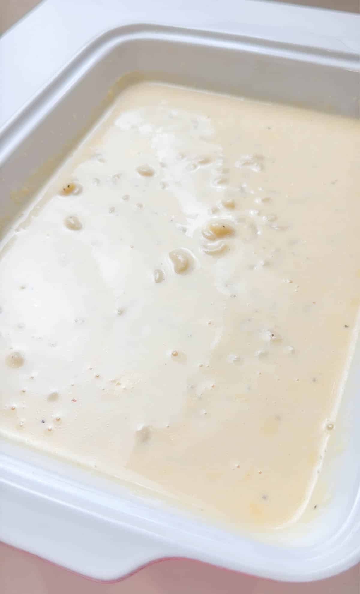 macaroni and cheese sauce in a white casserole dish