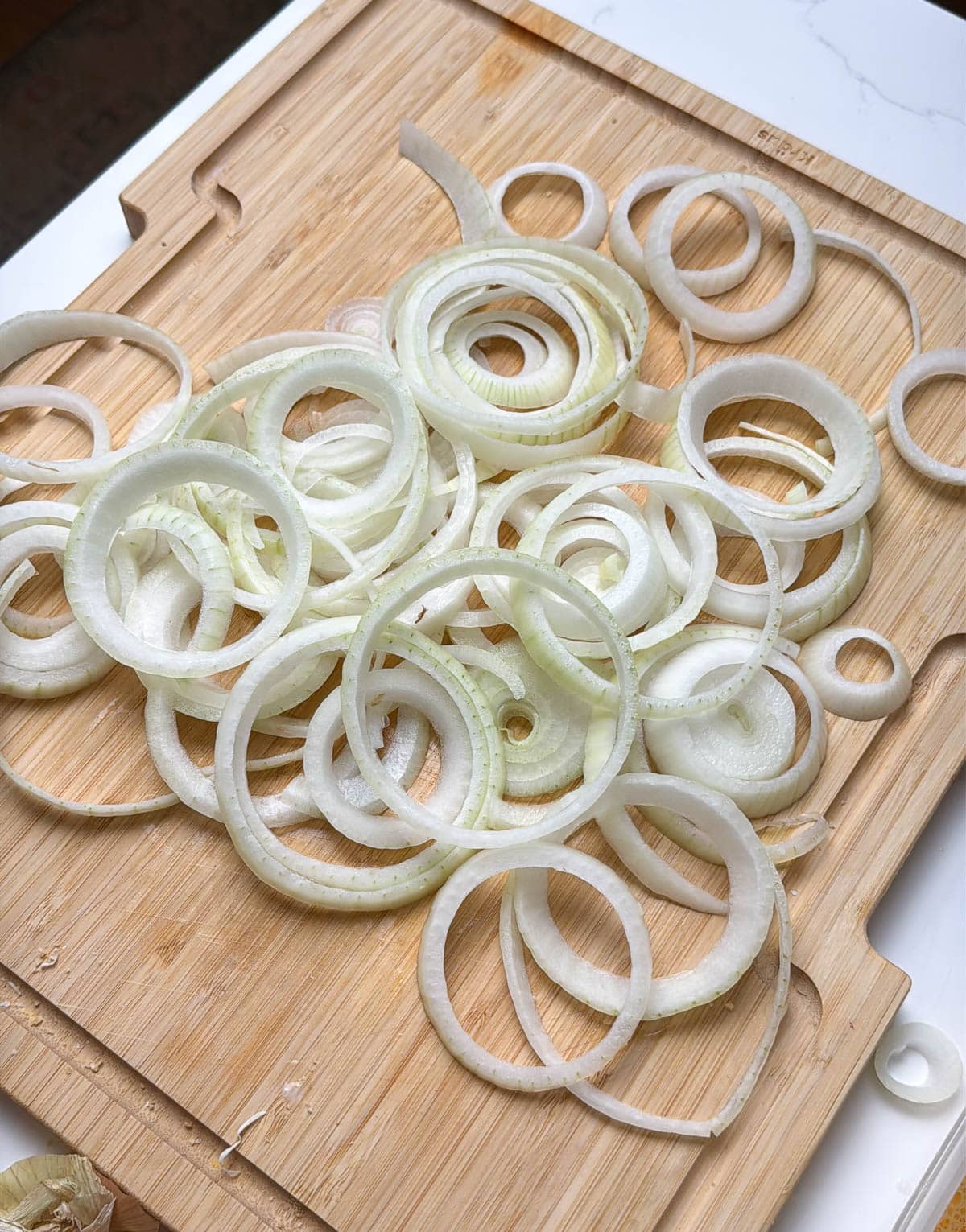 A sliced onion separated into rings.