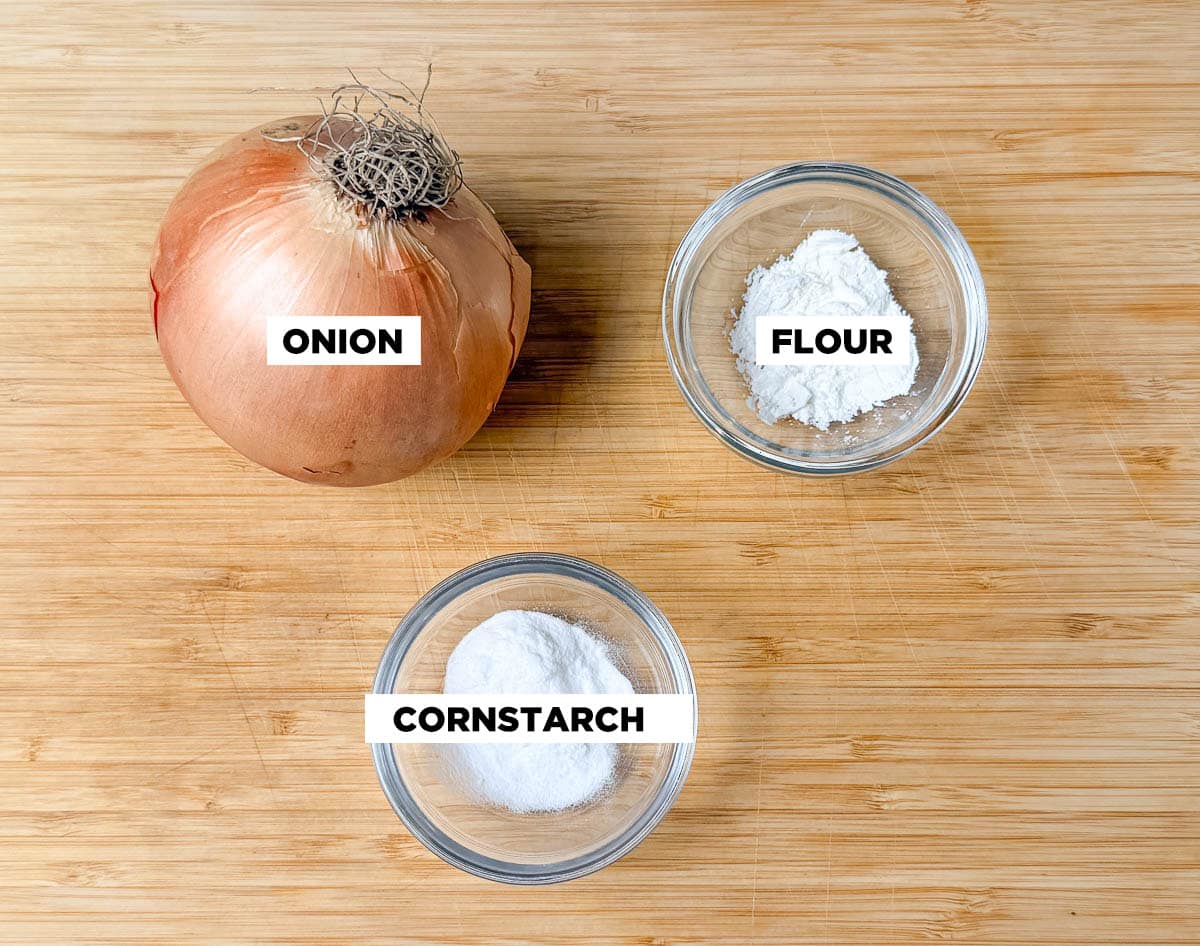 Ingredient shot for Crispy Fried Onions, featuring: an onion, flour, and cornstarch.
