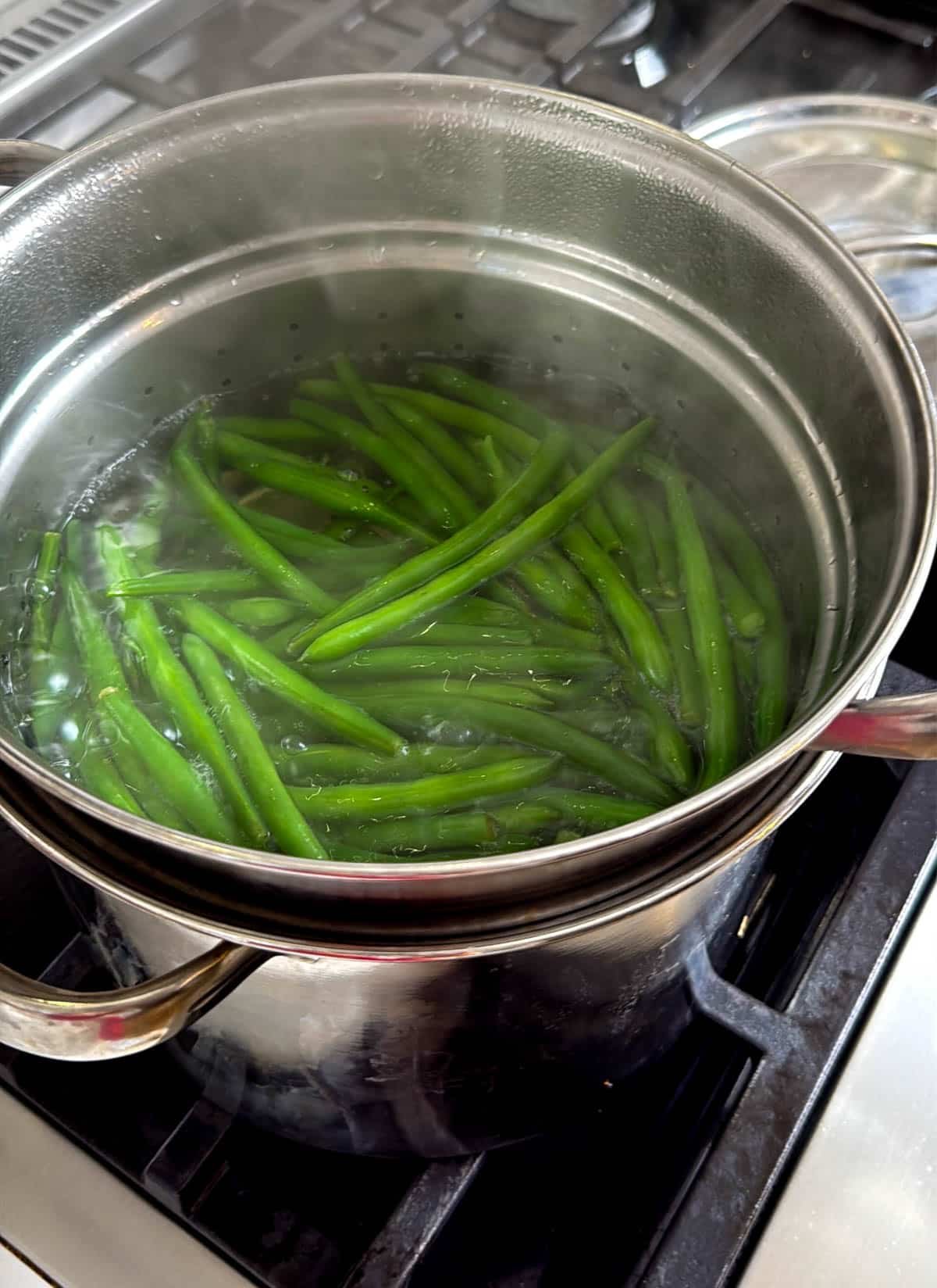 close up of green beans in a pot of boiling water