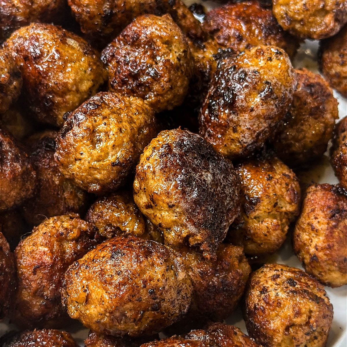 Close-up photo of fully-cooked ground turkey meatballs.