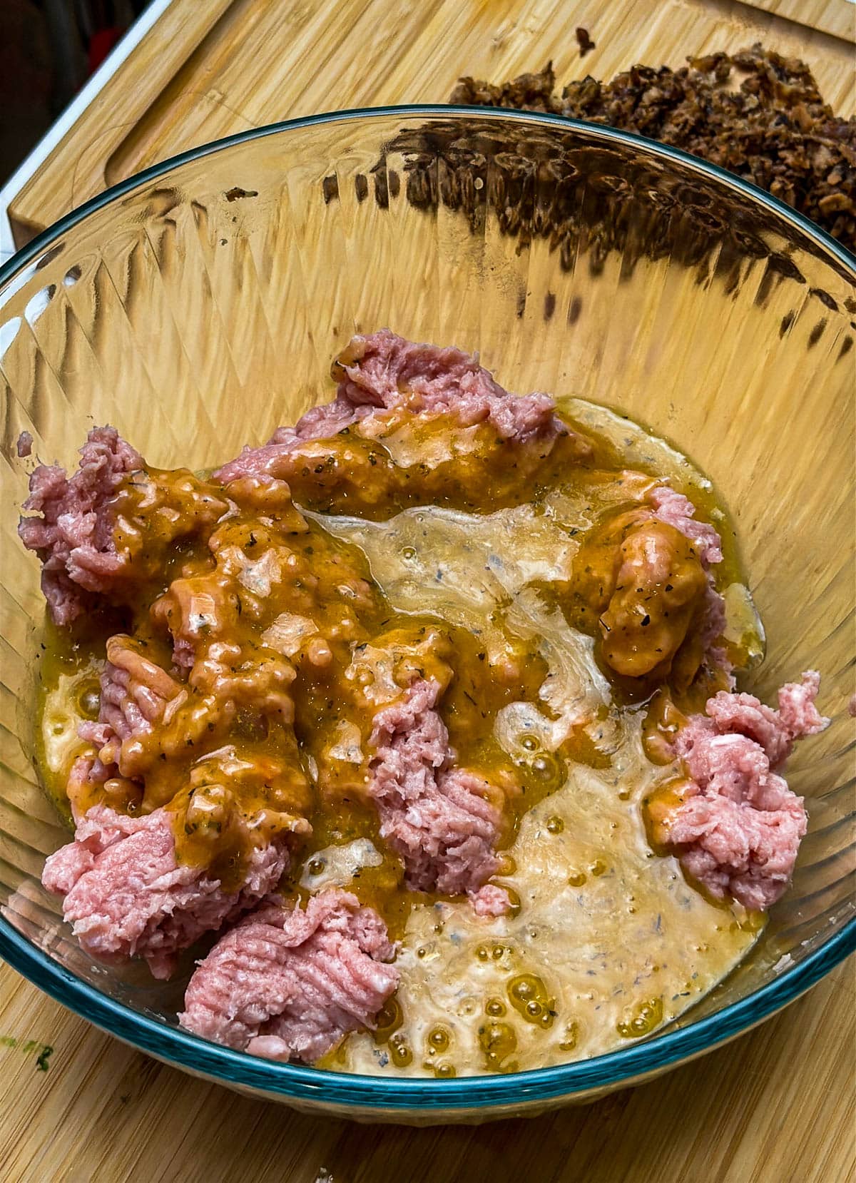 Ground turkey and wet ingredients are added together.