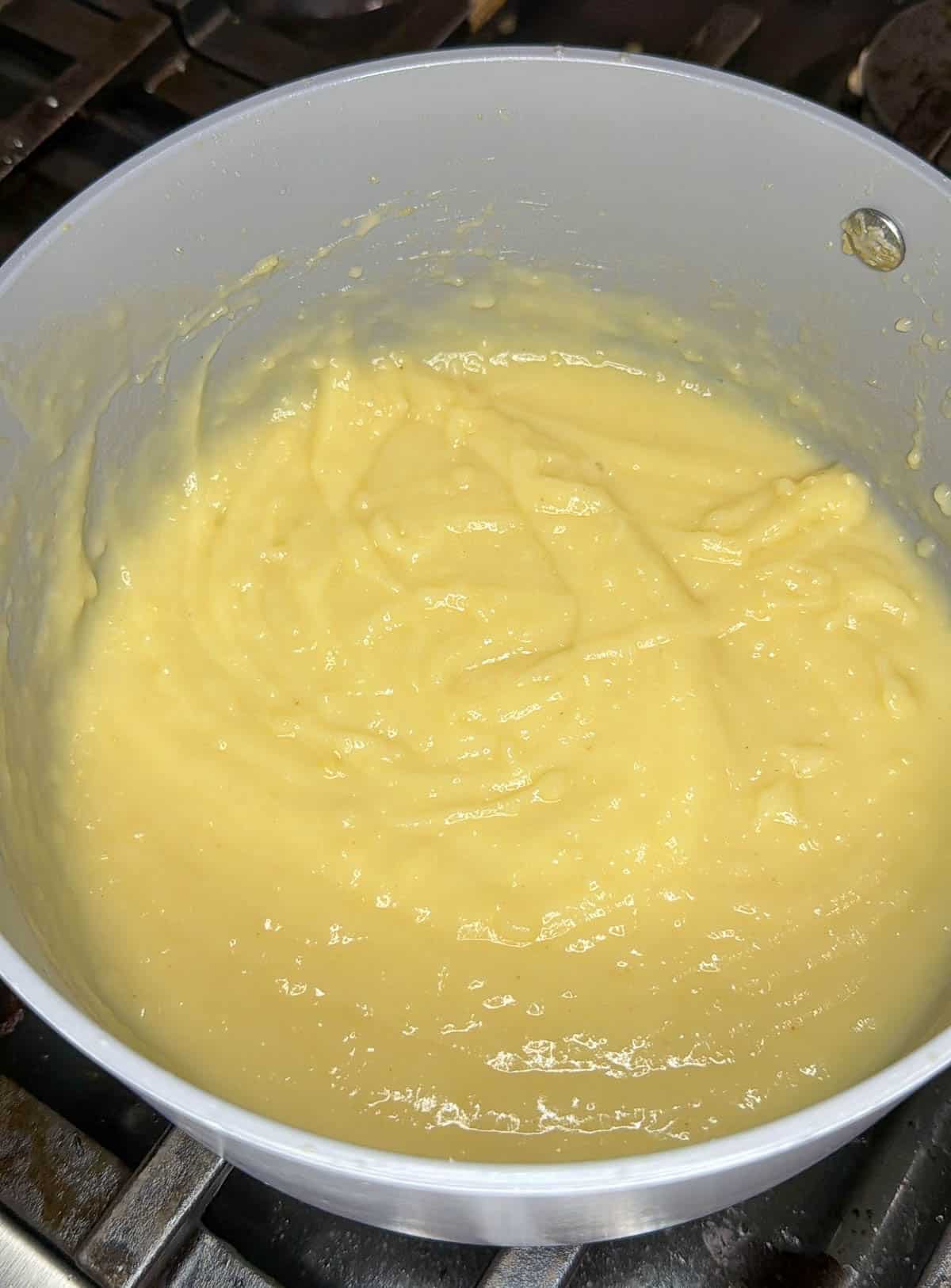 Milk is added to the flour and butter base to create a roux.