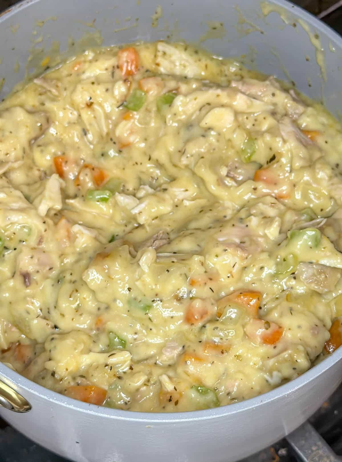 Cream of chicken soup and leftover turkey added to the mixture in the saucepan.