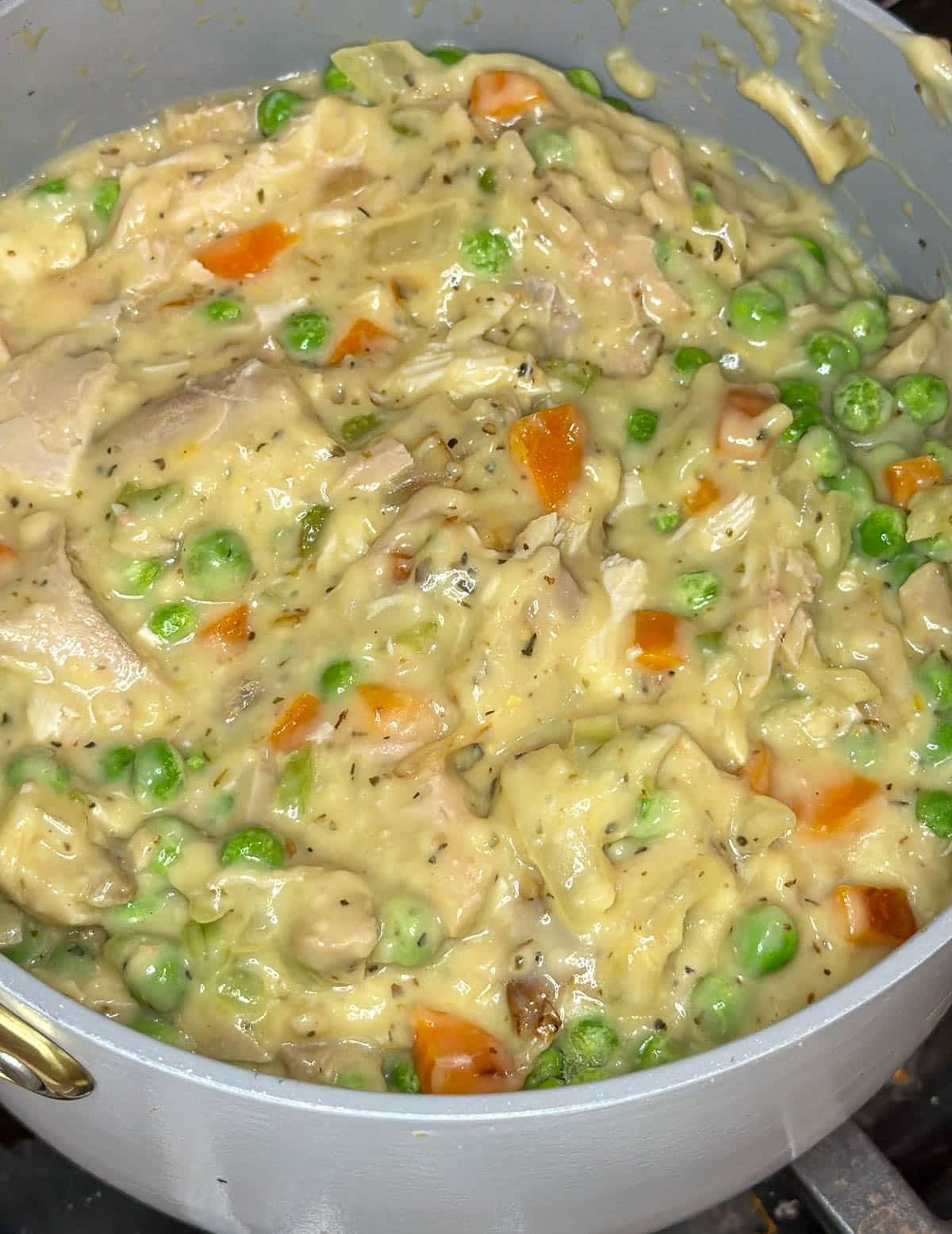 Frozen peas fully combined into the casserole mmixture.