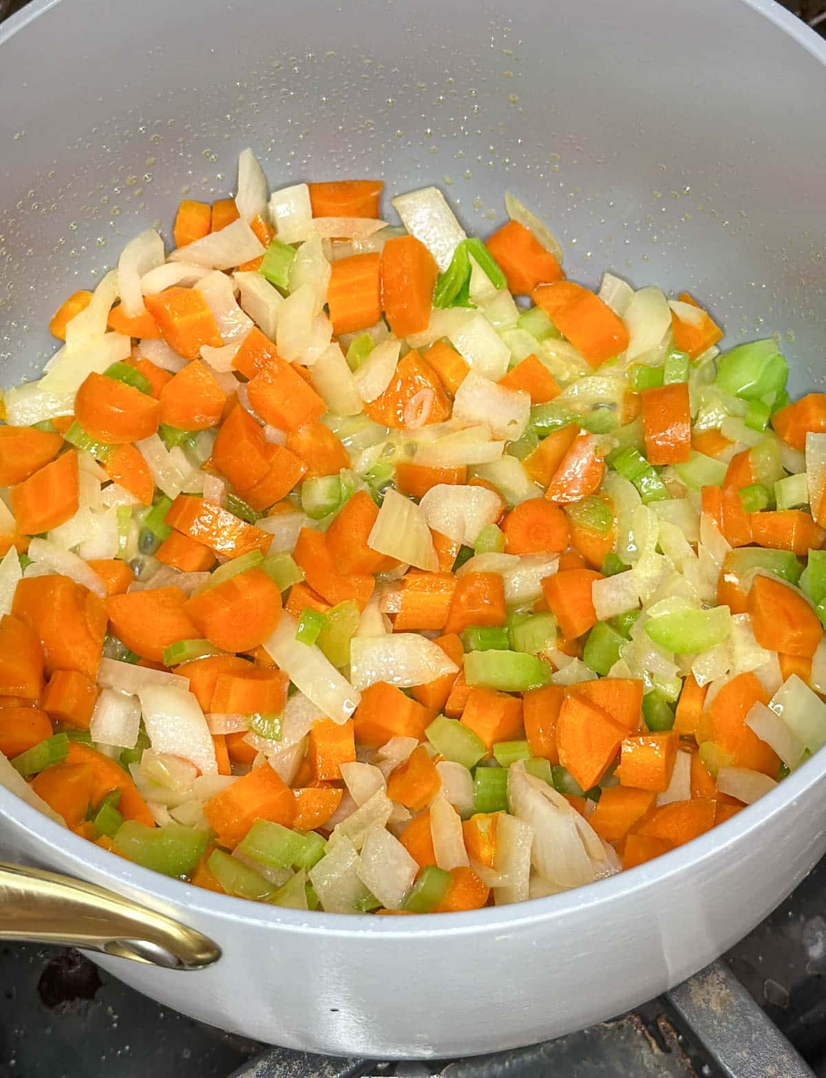 Chopped carrots, celery, and onion in saucepan.