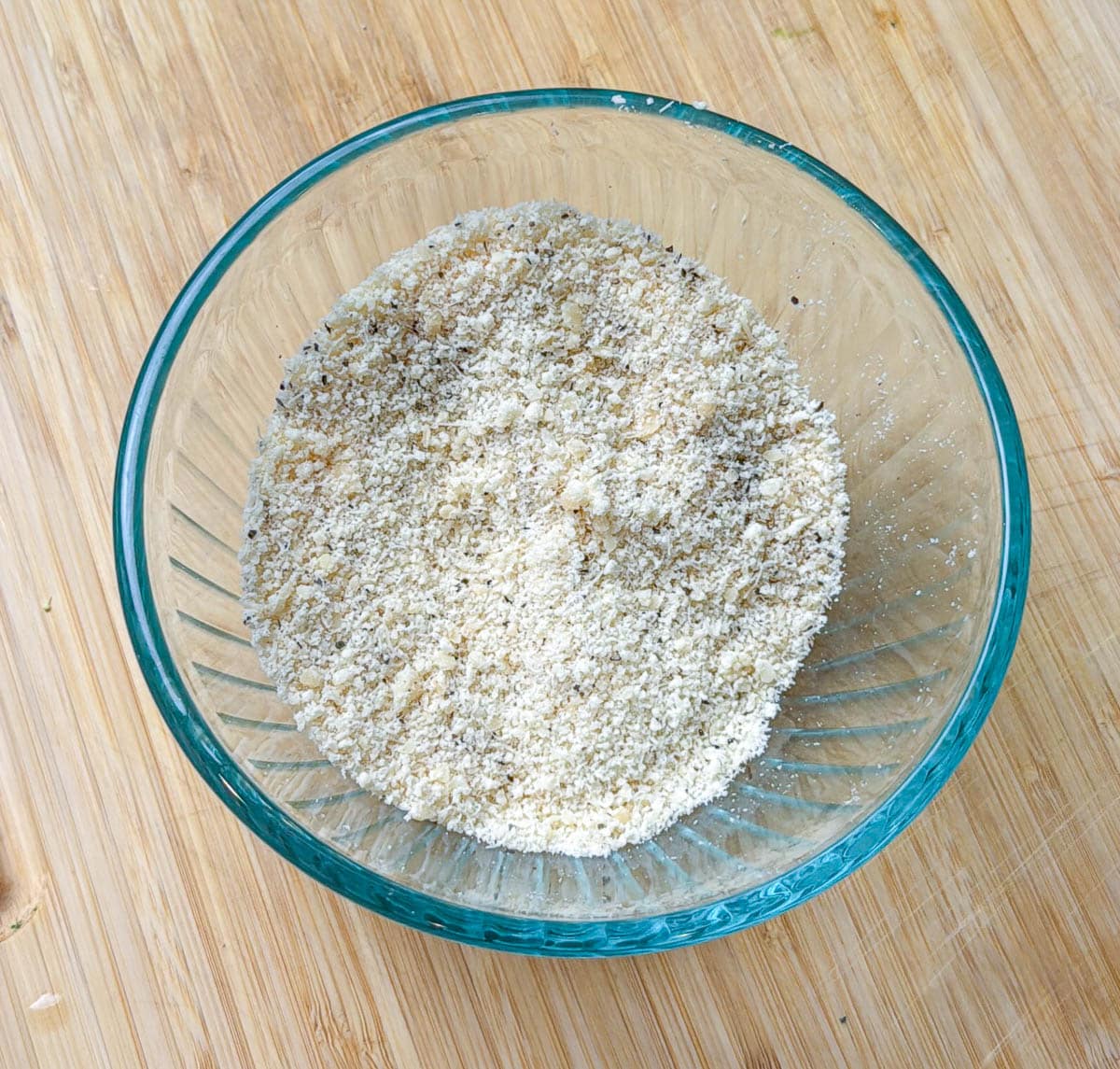 Parmesan cheese and seasoning mixture in a small bowl.
