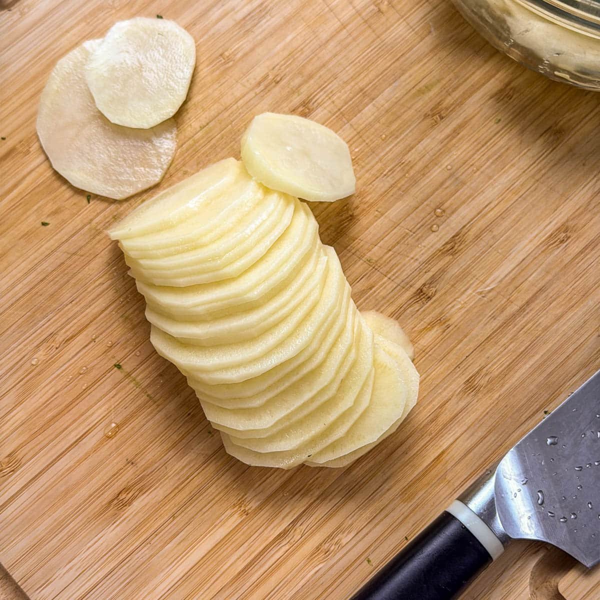 close up of sliced potatoes on a cutting board