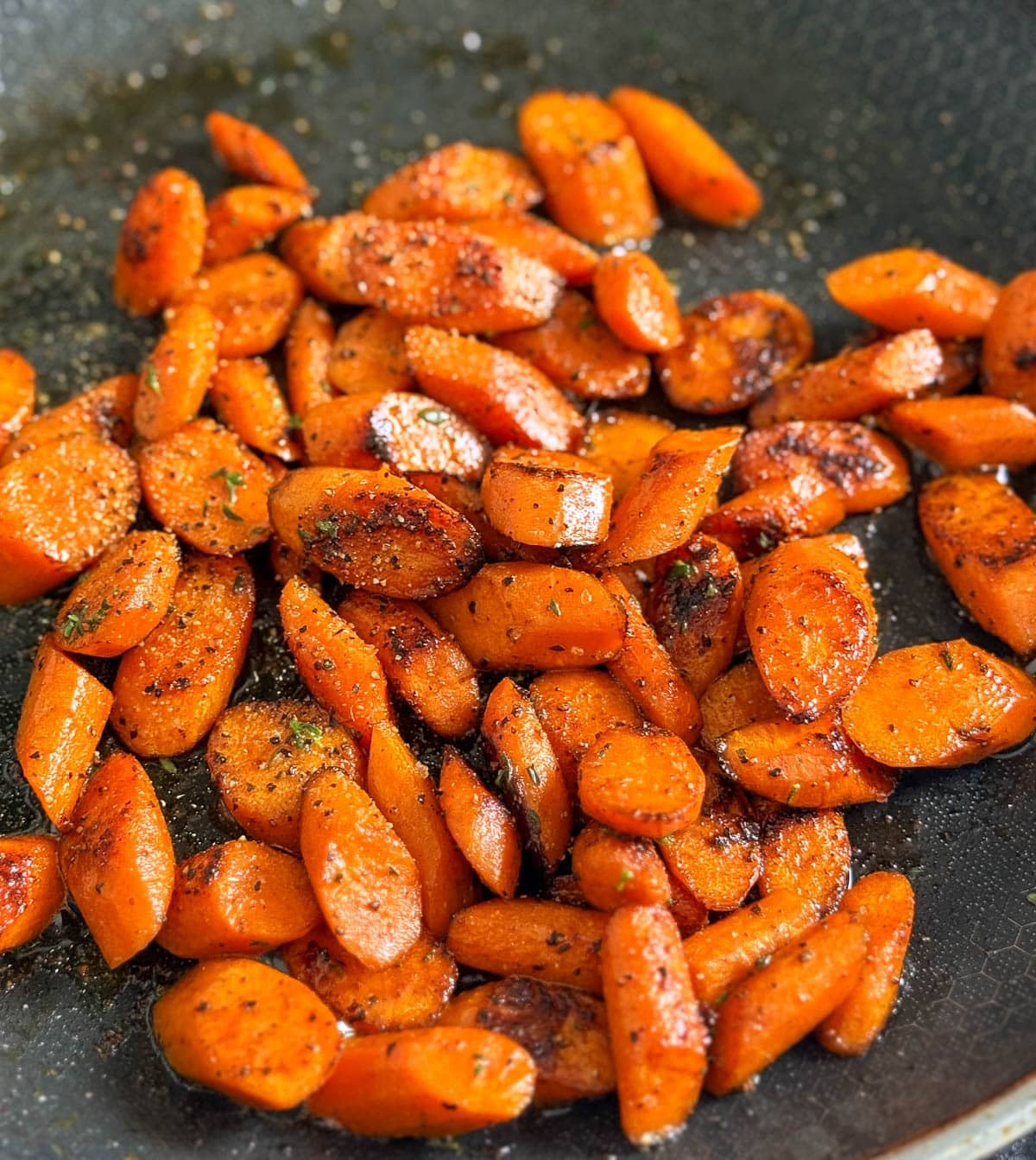 A close-up photo of sautéed carrots.