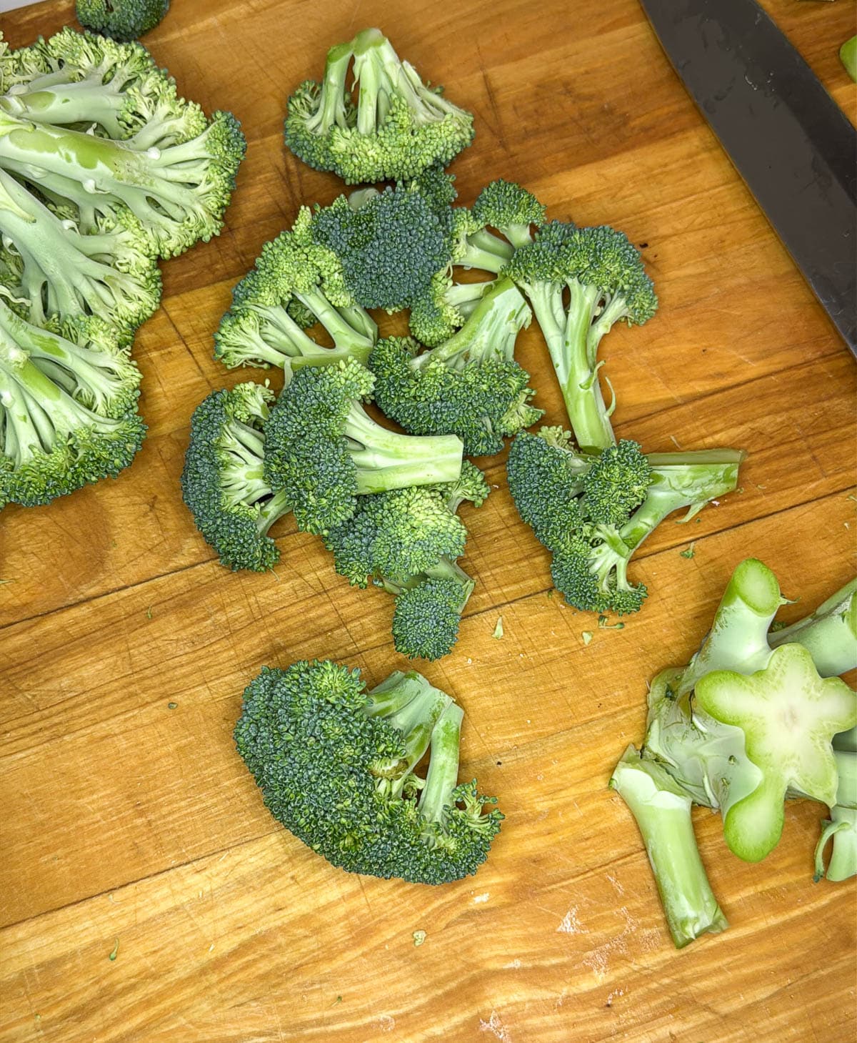 The head of broccoli with the stem cut off.