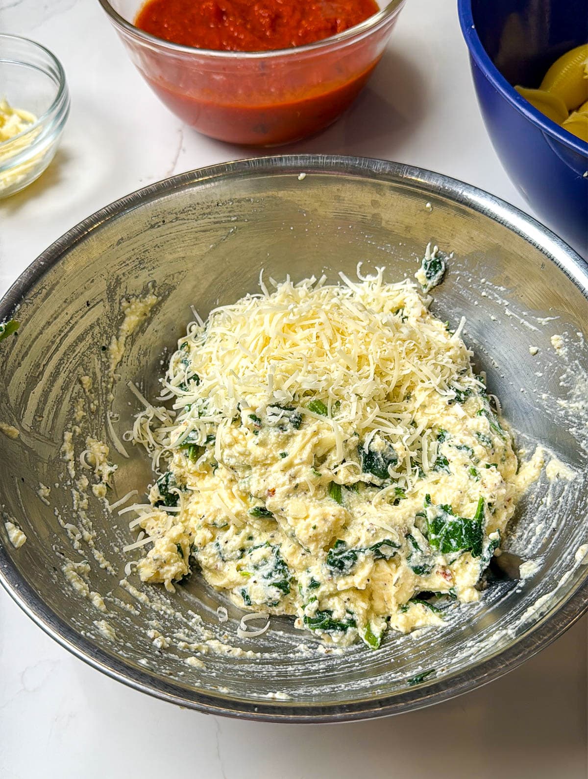 Parmesan cheese added to the cheese and spinach mixture.