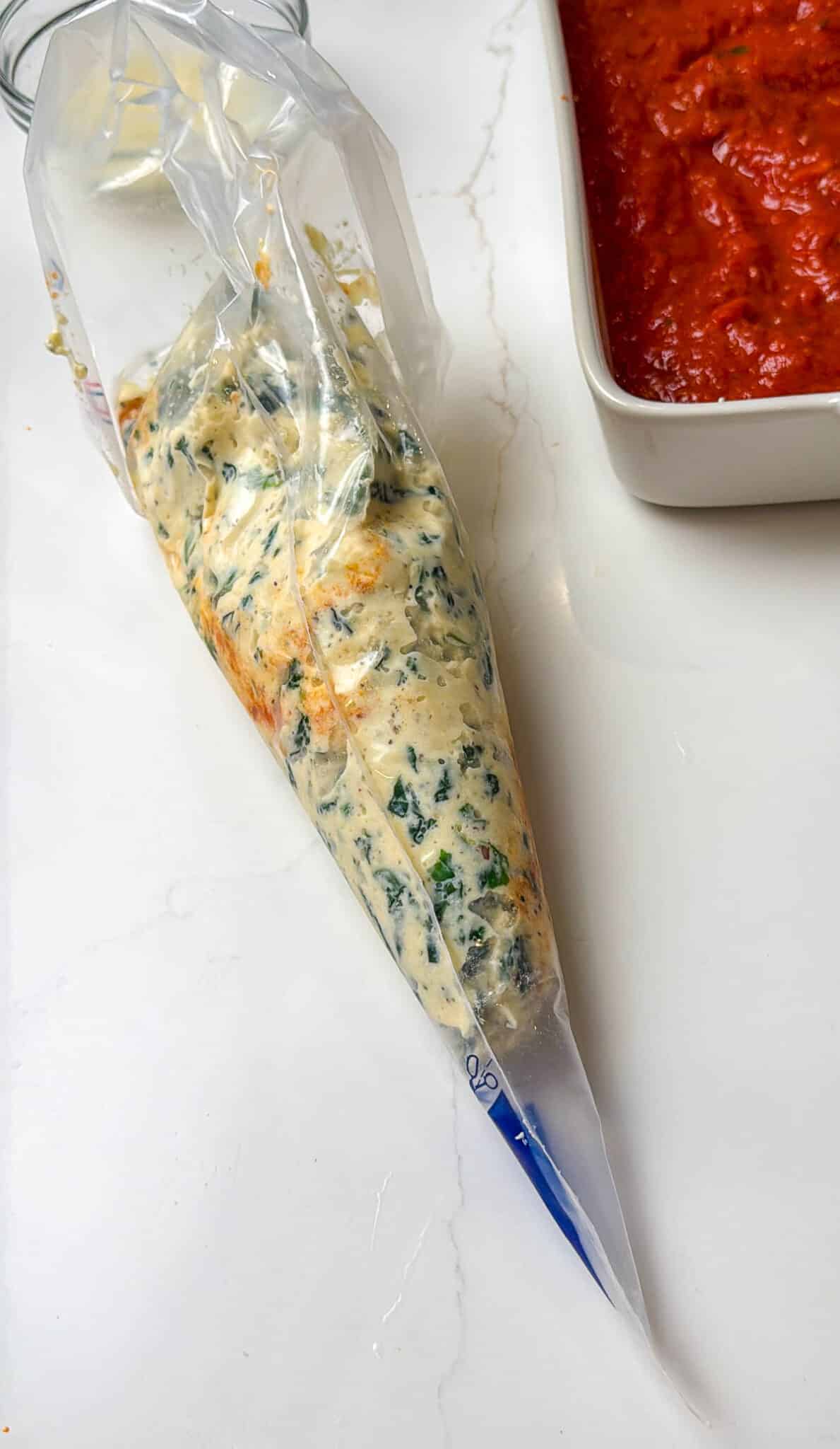 Piping bag filled with ricotta mixture.