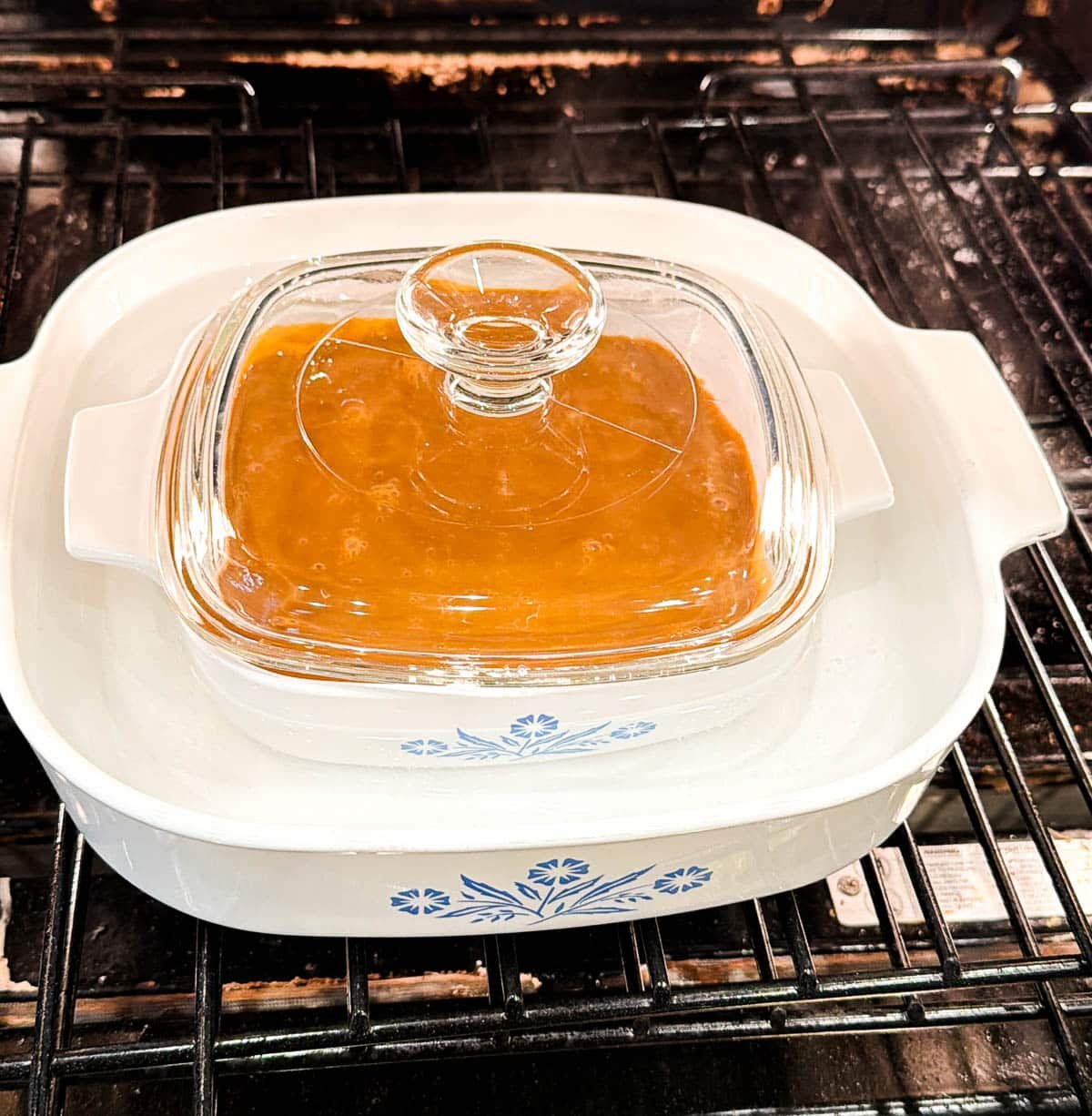 dulce de leche in a casserole dish in a water bath in the oven