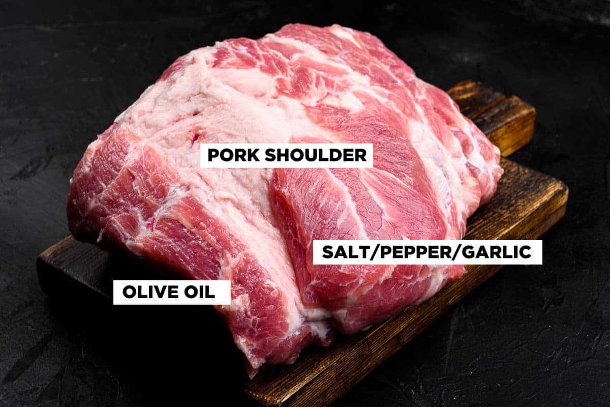 Pork shoulder fresh raw meat on black dark stone table background.