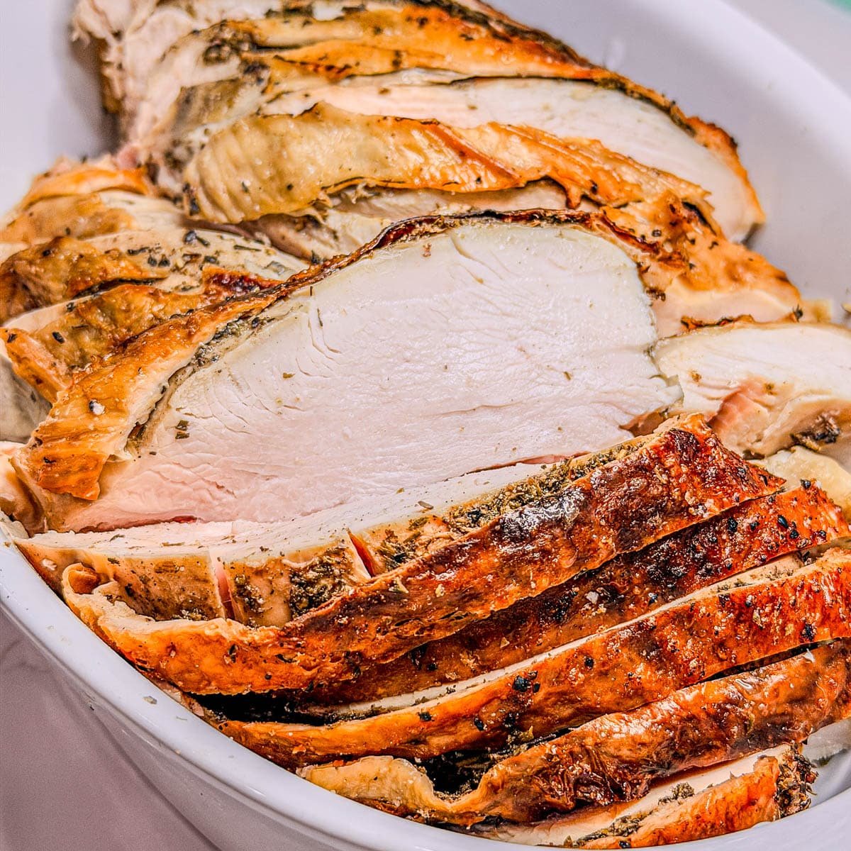 A close-up photo of a roasted, sliced spatchcock turkey.