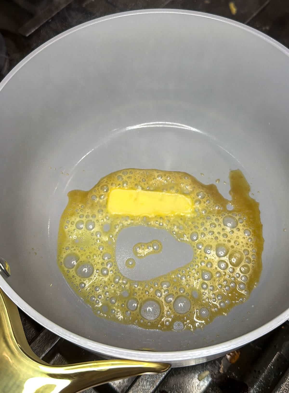 Butter elting in a pot.