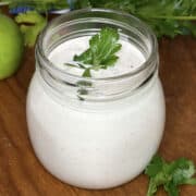 close up of a jar of cilantro lime crema