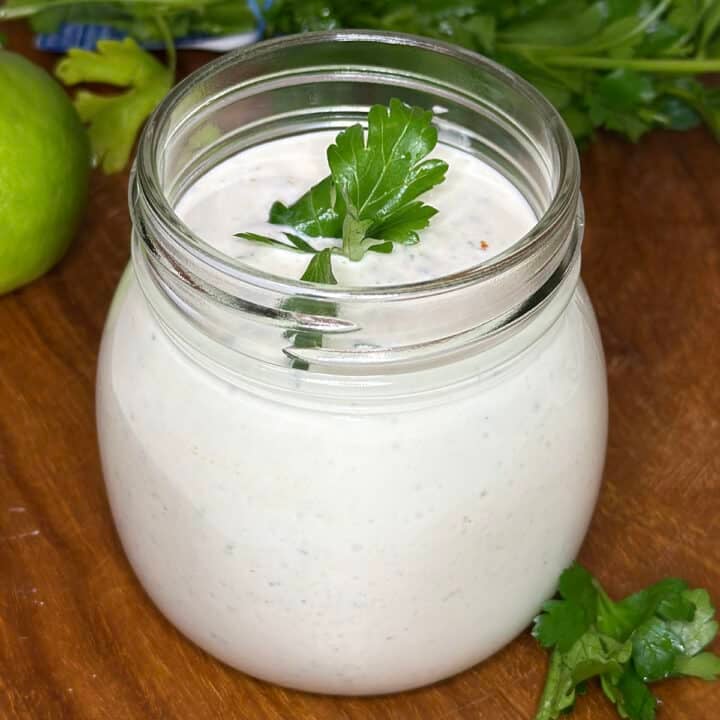 close up of a jar of cilantro lime crema