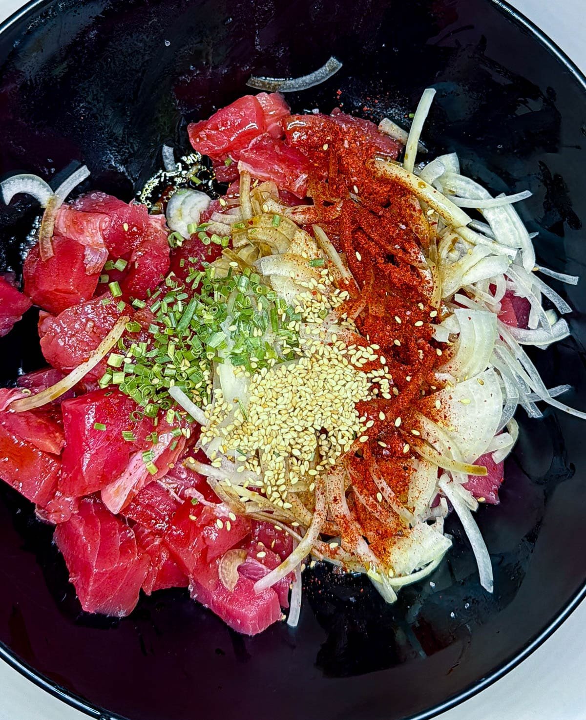 poke ingredients in a black bowl
