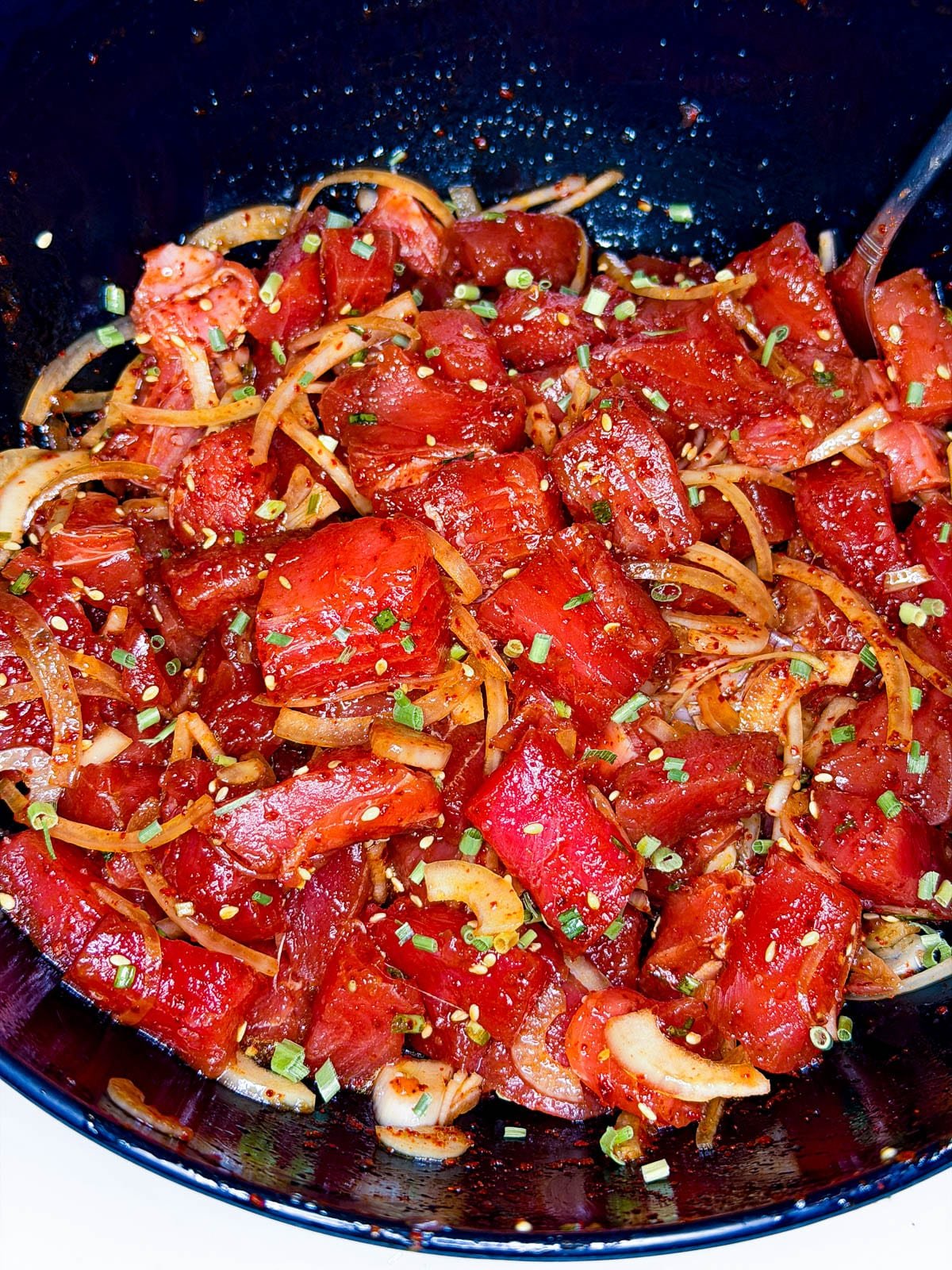 close up of poke in a black bowl