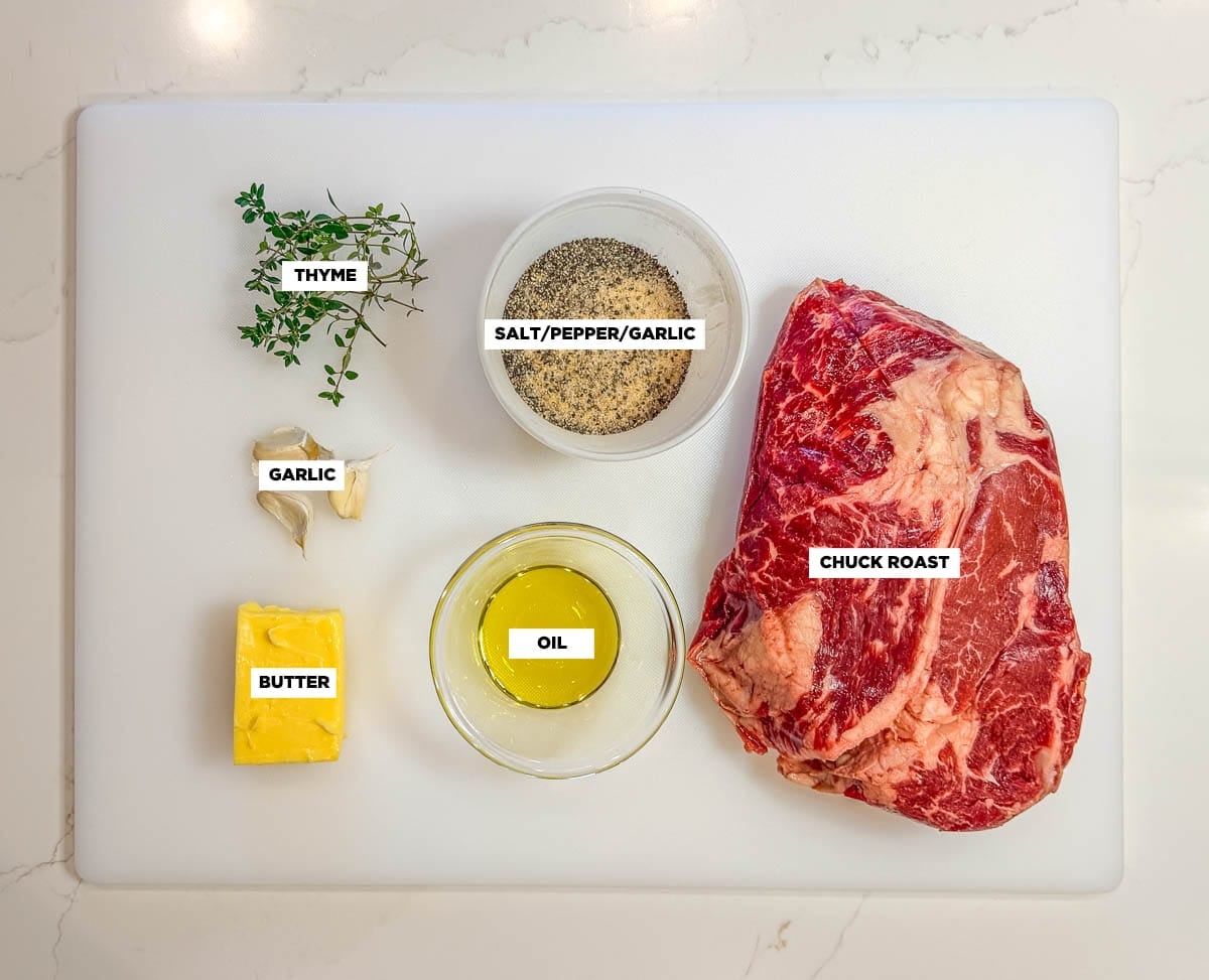Instant pot pot roast ingredients on a cutting board on a white countertop.