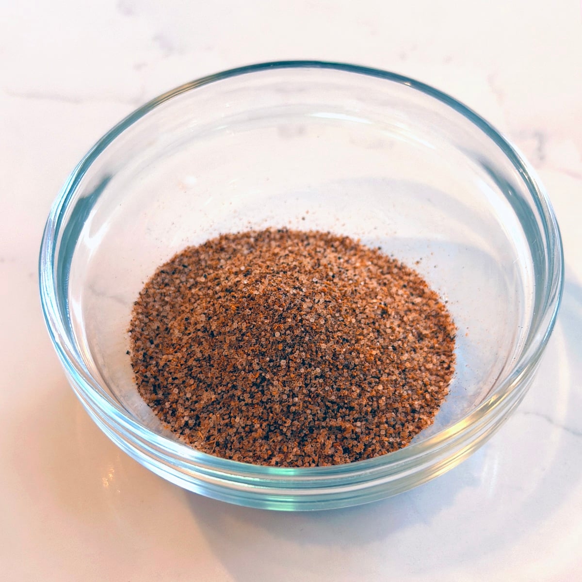 Blended spice mix in a small clear glass bowl.