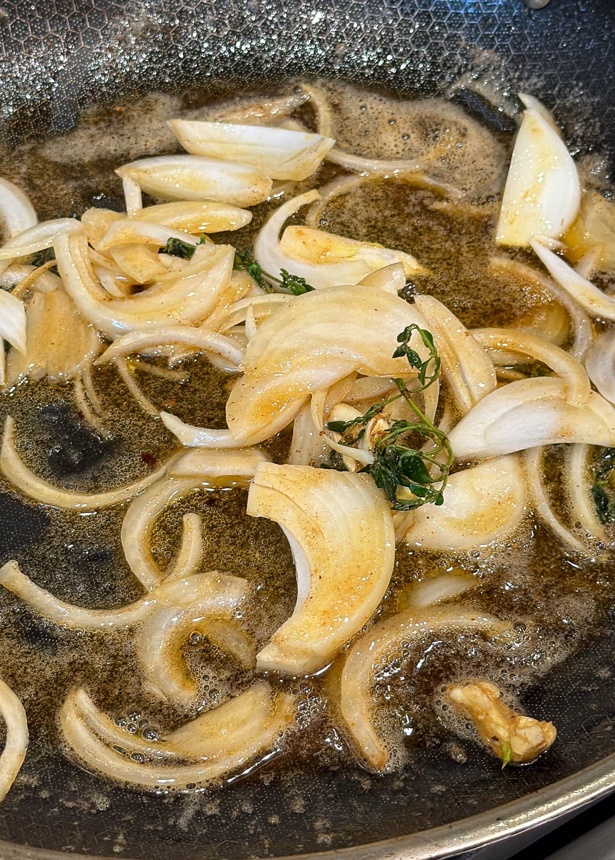 Onions, garlic, thyme, and butter in a saute pan.