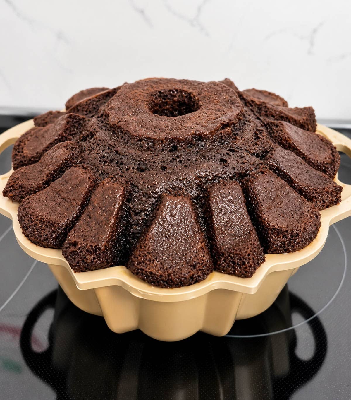 Baked wine cake in a gold bundt cake pan.