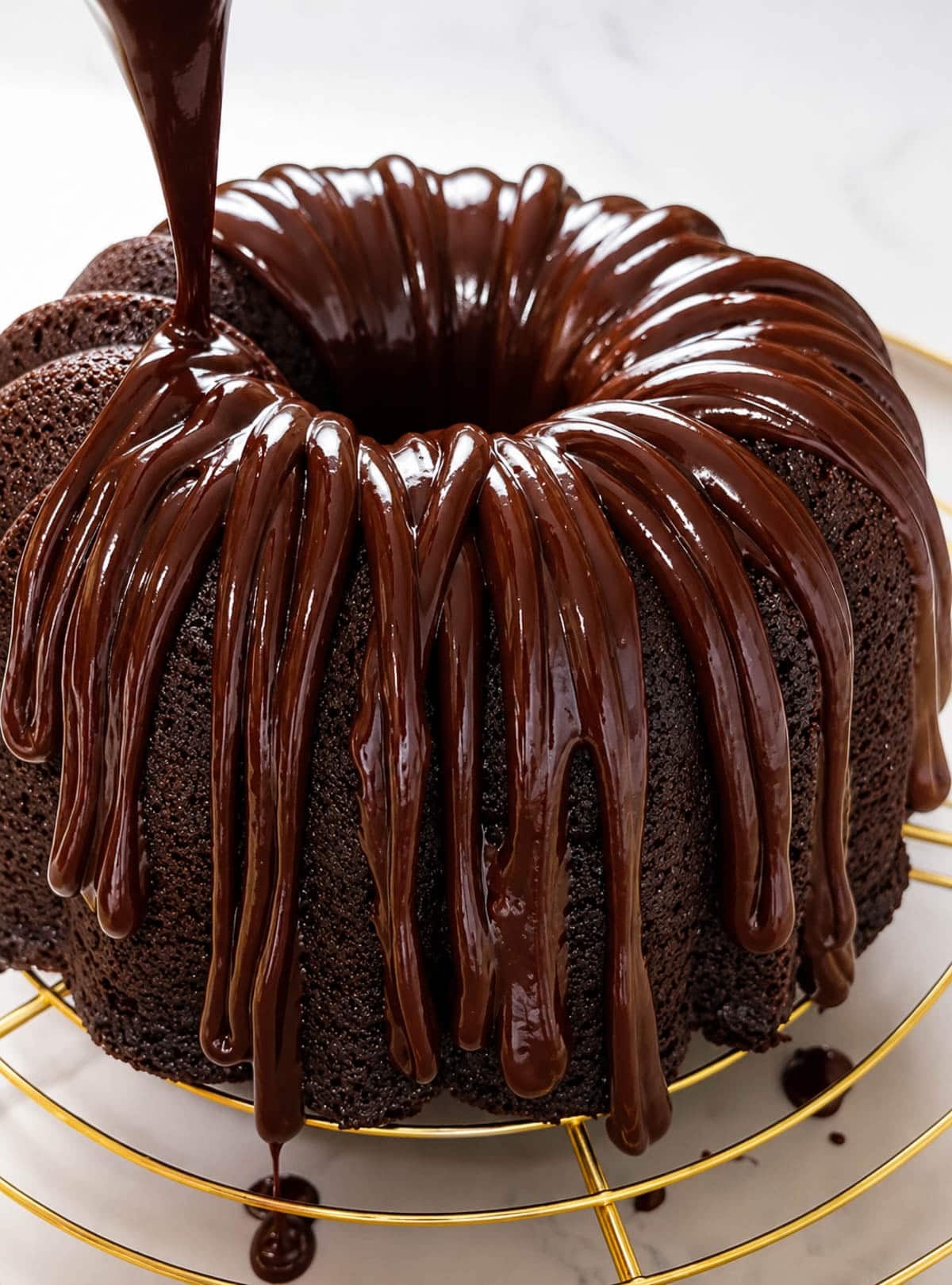 Drizzling wine ganache over a chocolate bundt cake.