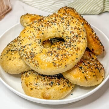 Sourdough discard bagels on a white plate.