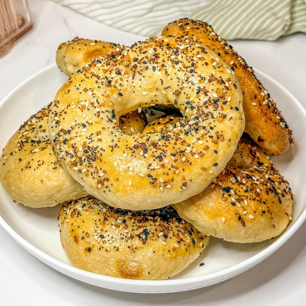 Sourdough discard bagels on a white plate.