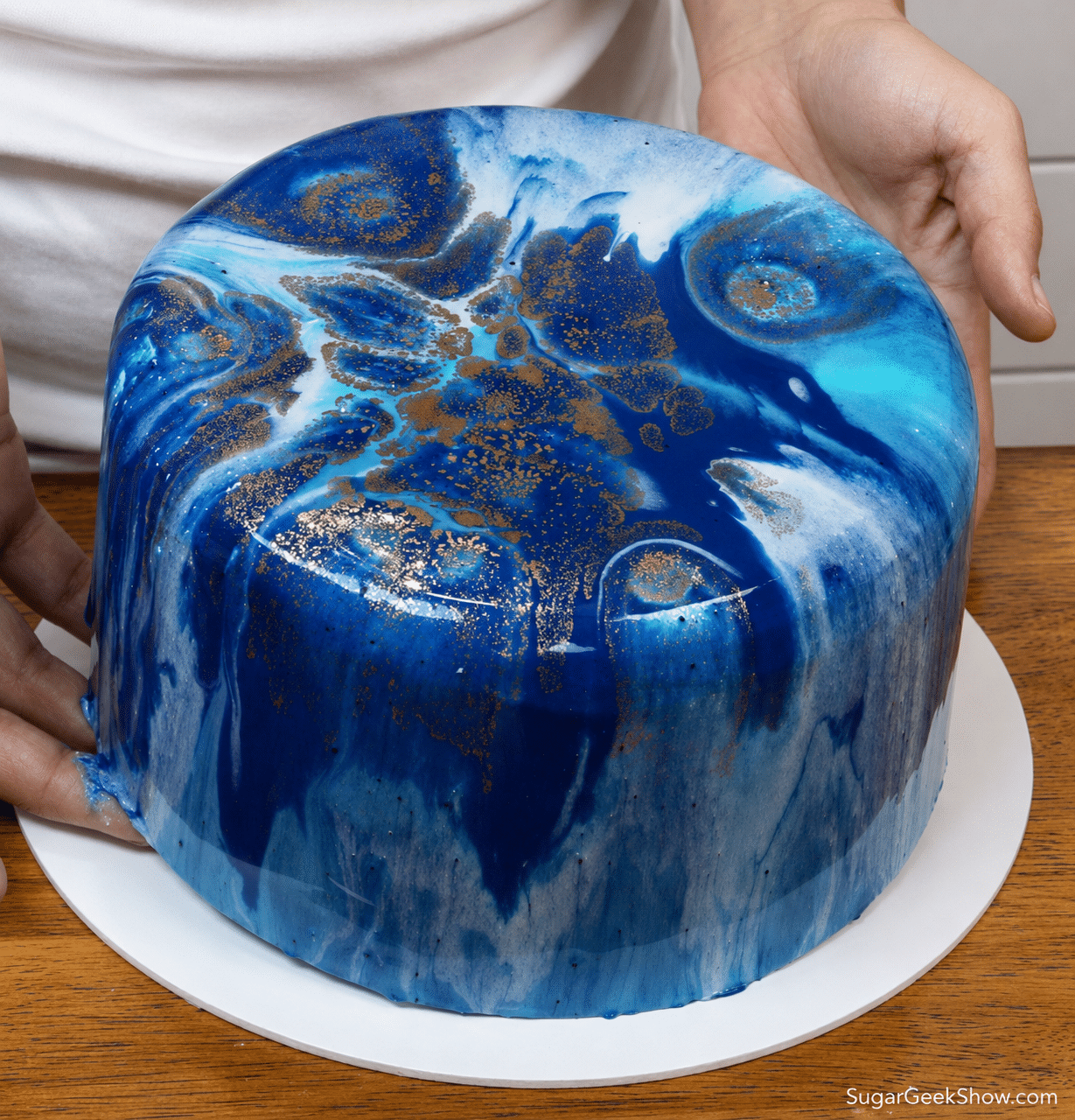Placing the finished cake onto the cake board.