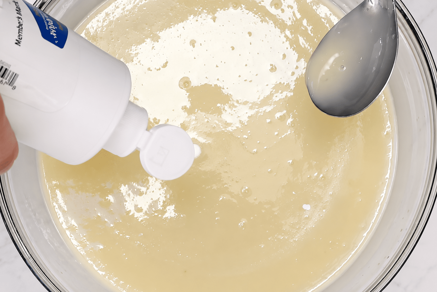 Adding white food coloring to the glaze.