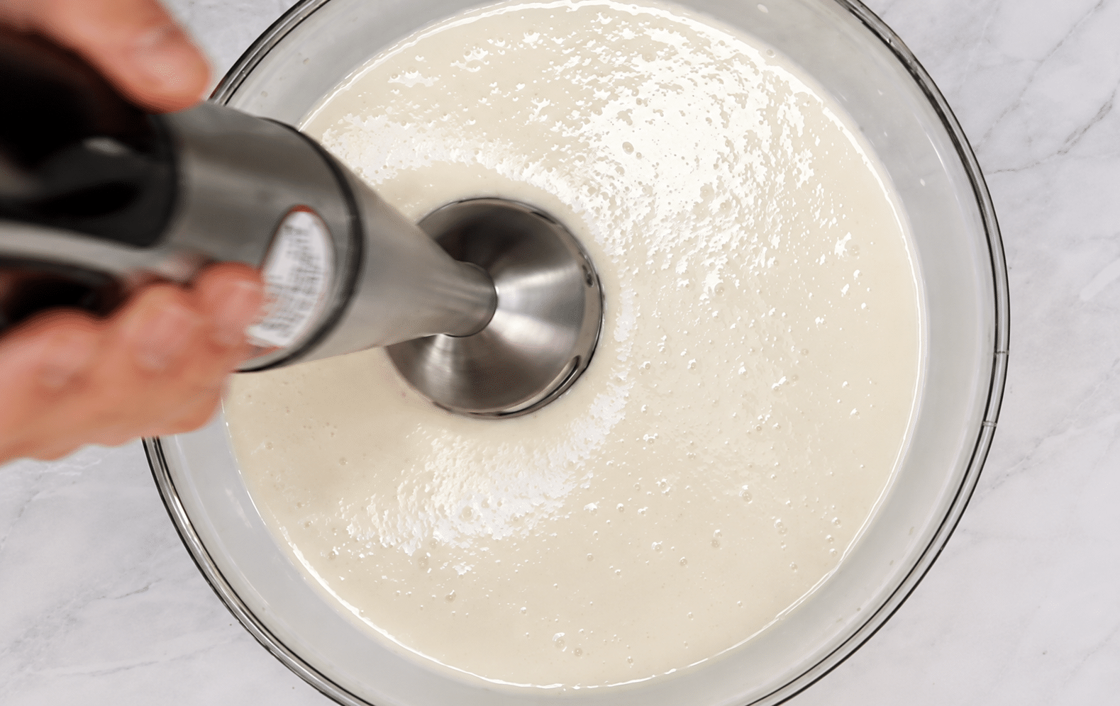 Immersion blender in the mirror glaze.