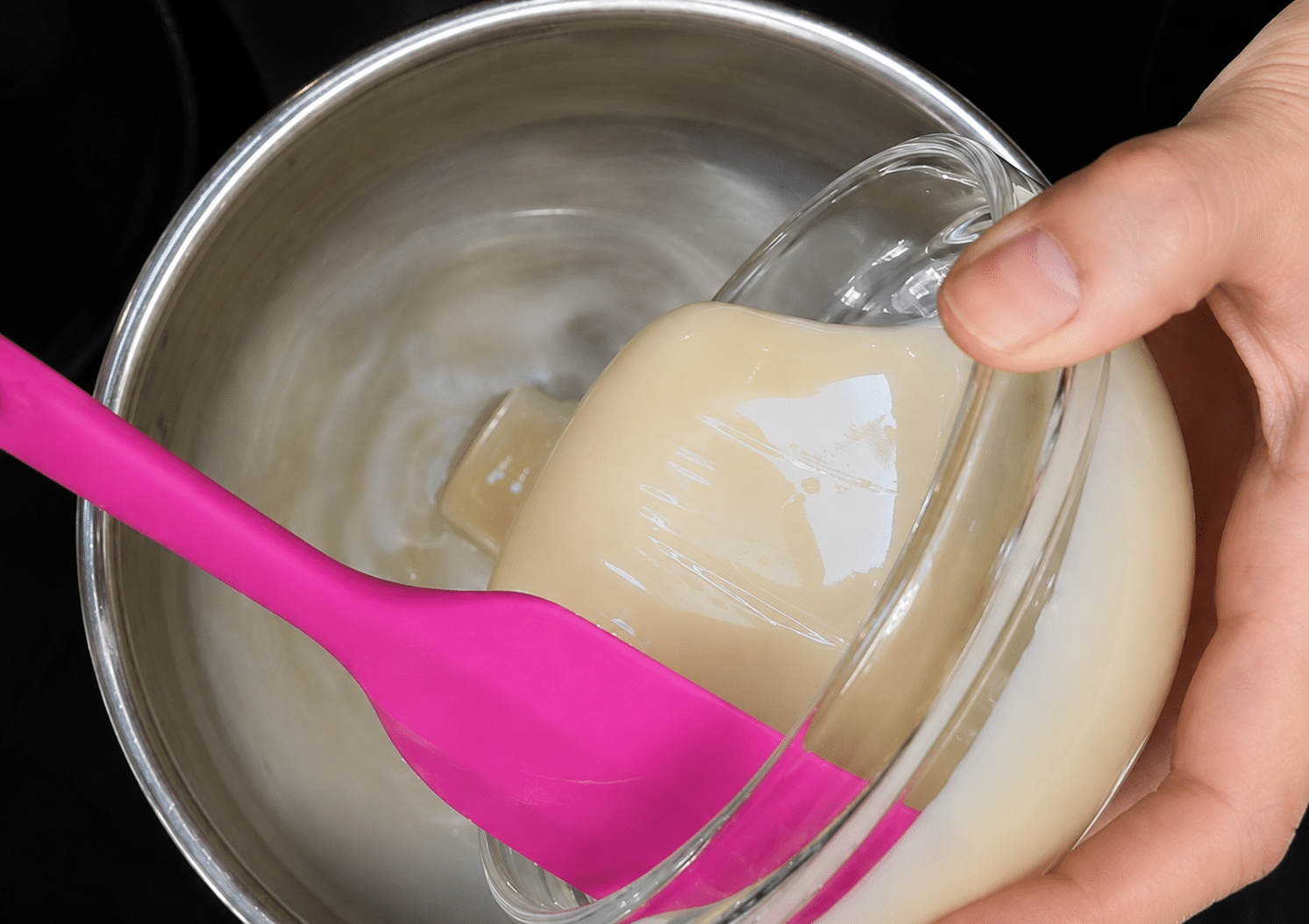 Combining the sweetened condensed milk with the water and sugar, in a medium saucepan.