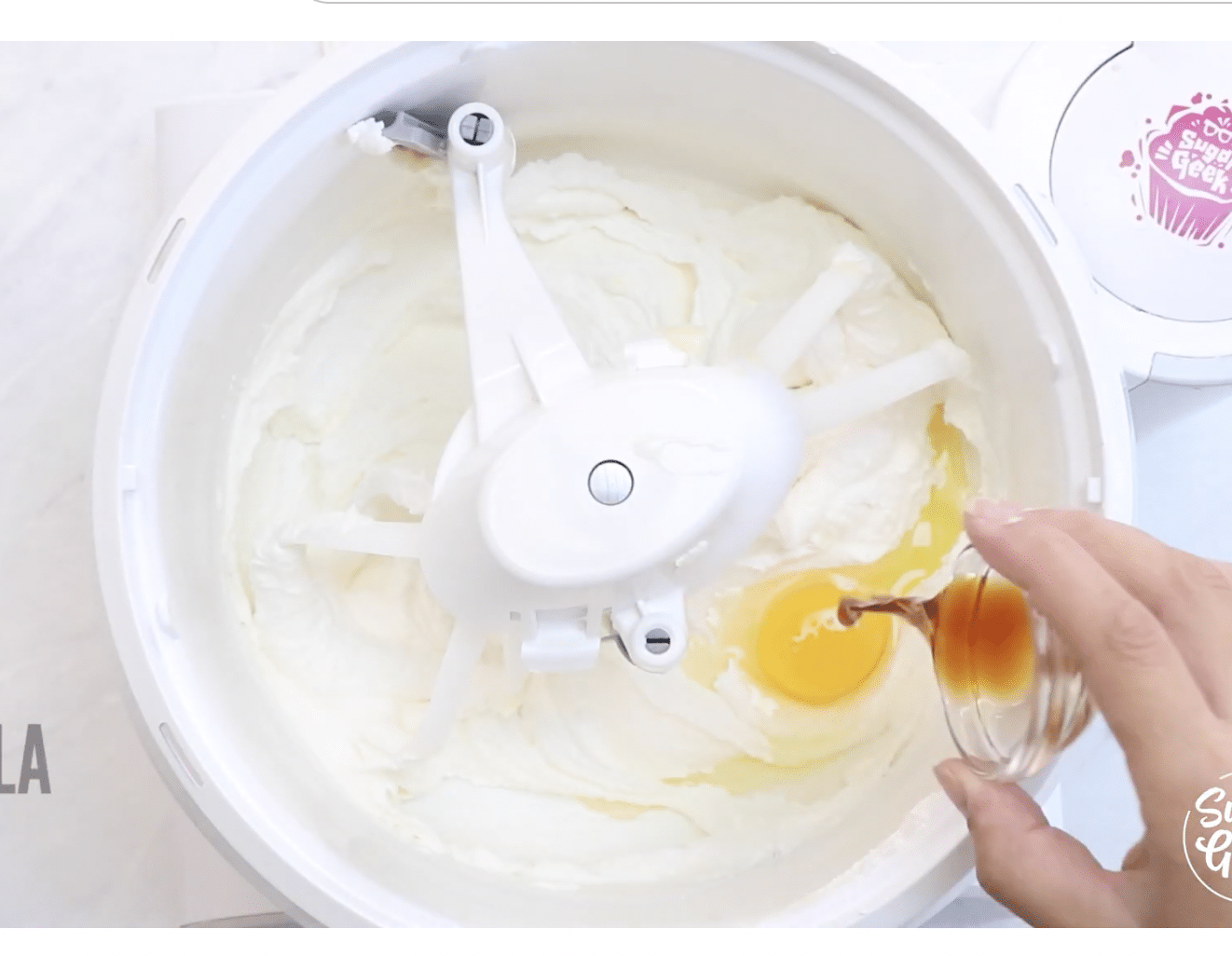 An egg and vanilla extract added to the whipped mixture.