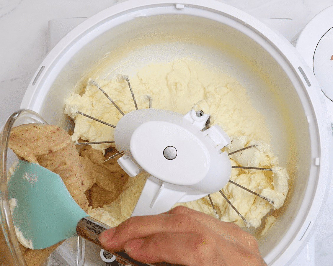 Browned butter being added to the cream cheese and butter mixture.