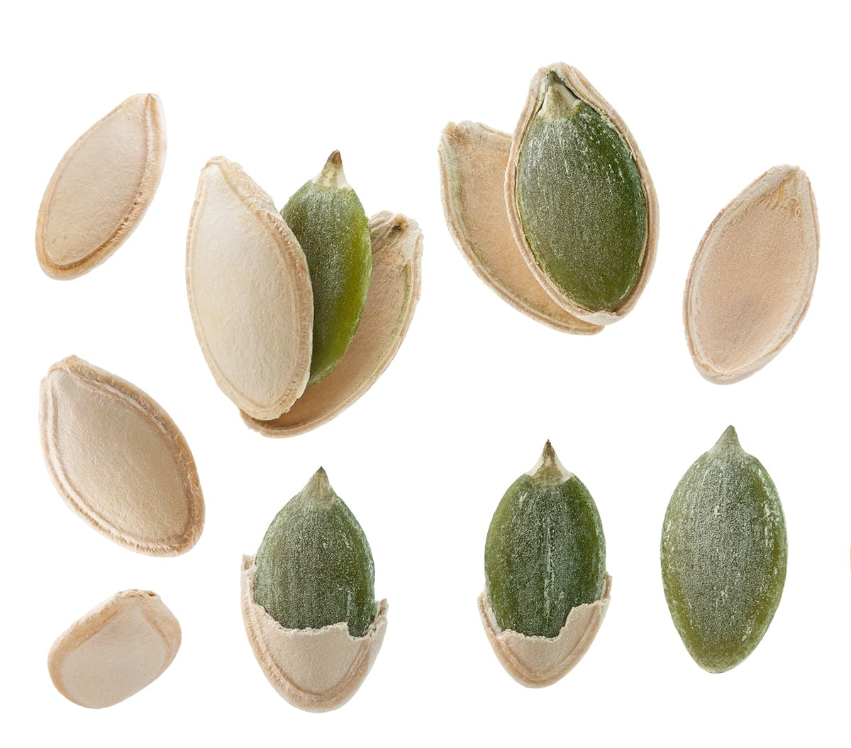 whole pumpkin seed with shell next to a shelled green pepita