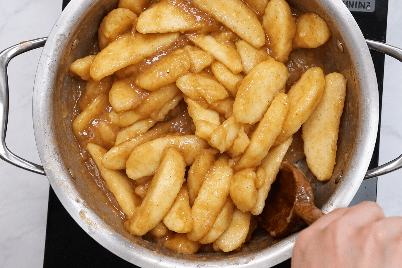 Apple pie filling cooked until thickened.