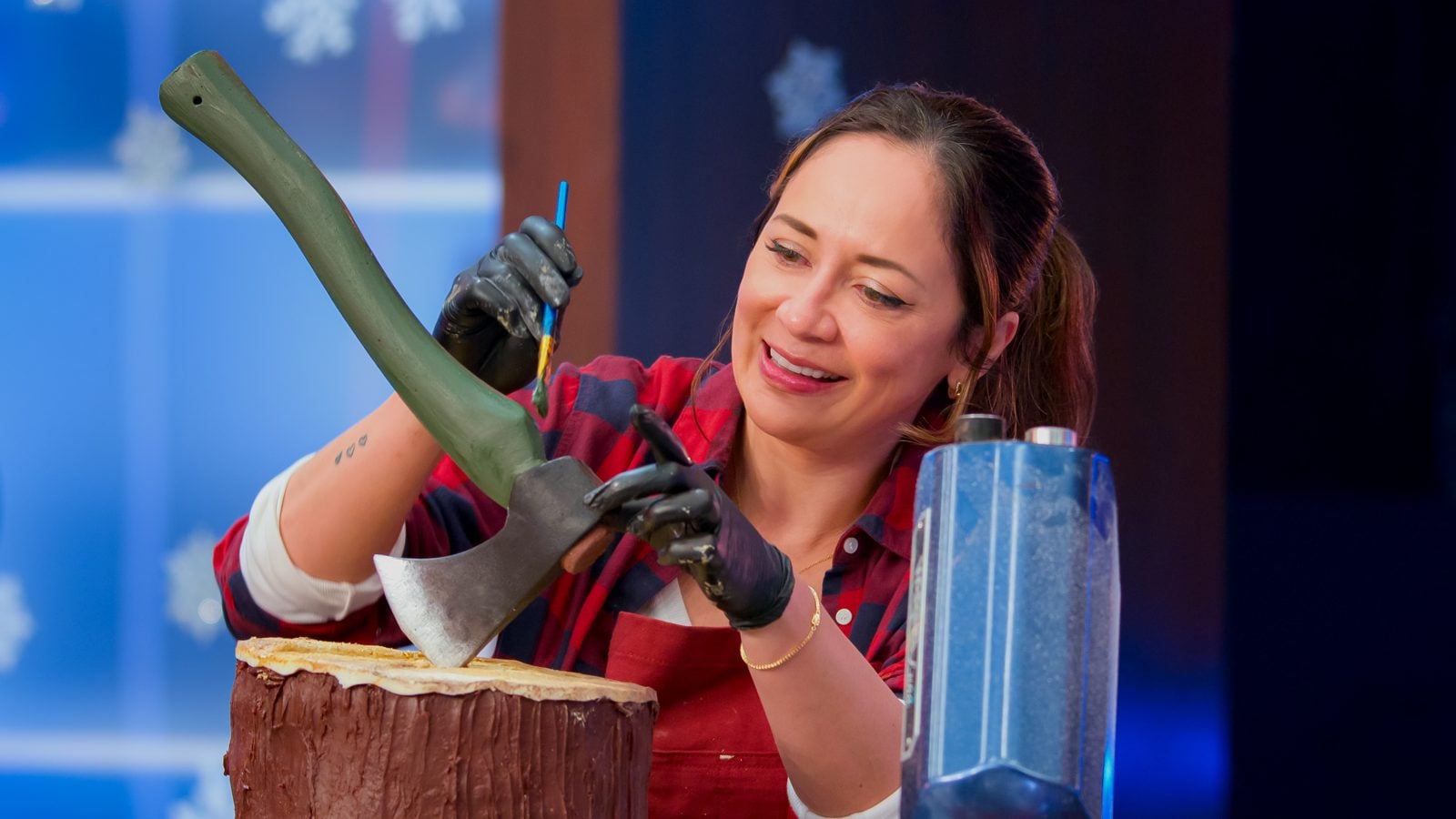 Liz Marek carving cake on Is It Cake? Holiday